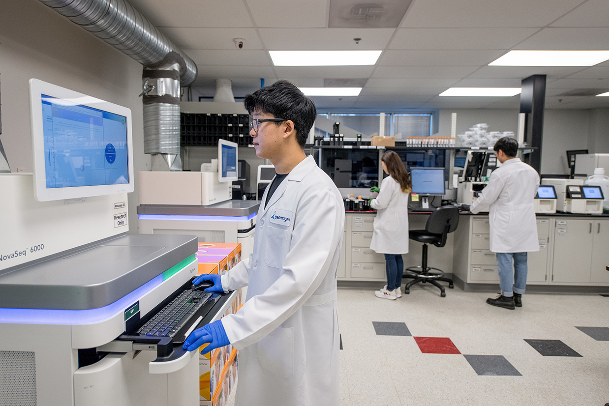 Three scientists working in NGS lab with Illumina NovaSeq and HiSeq instruments