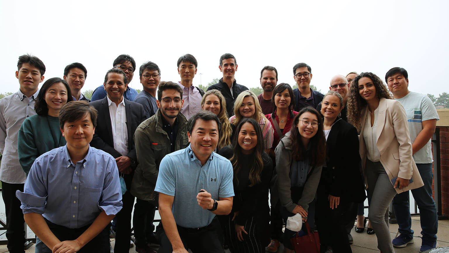 Group shot near Psomagen’s Maryland headquarters on a balcony near a pond